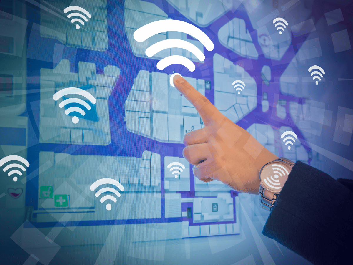 A hand pointing to a Wi-Fi symbol on a digital heat mapping background, surrounded by multiple Wi-Fi icons.