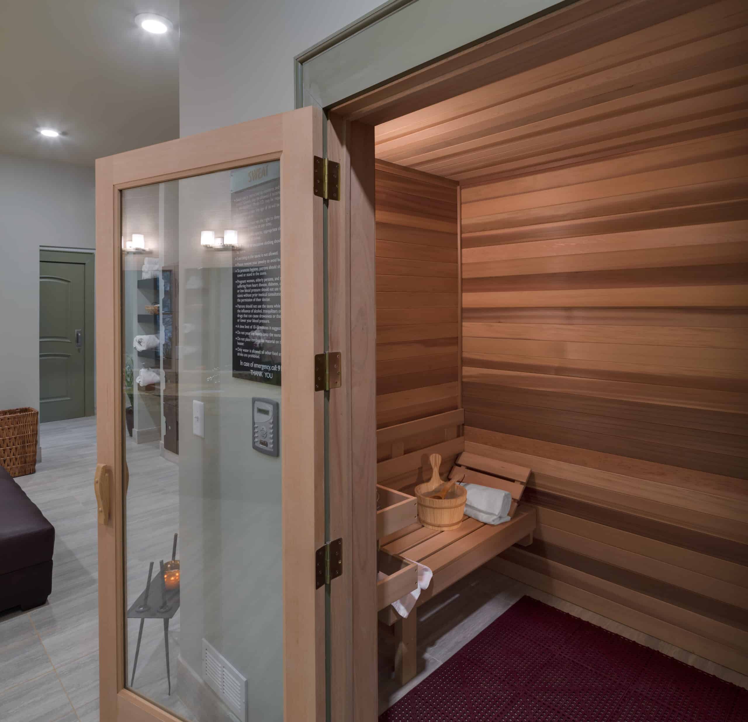 A room with a sauna and a wooden bench.