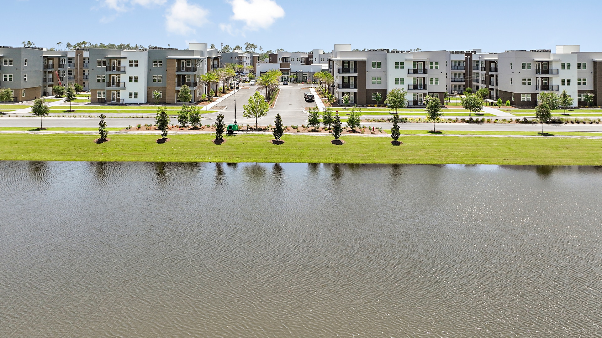 An aerial view of a residential area with a pond.