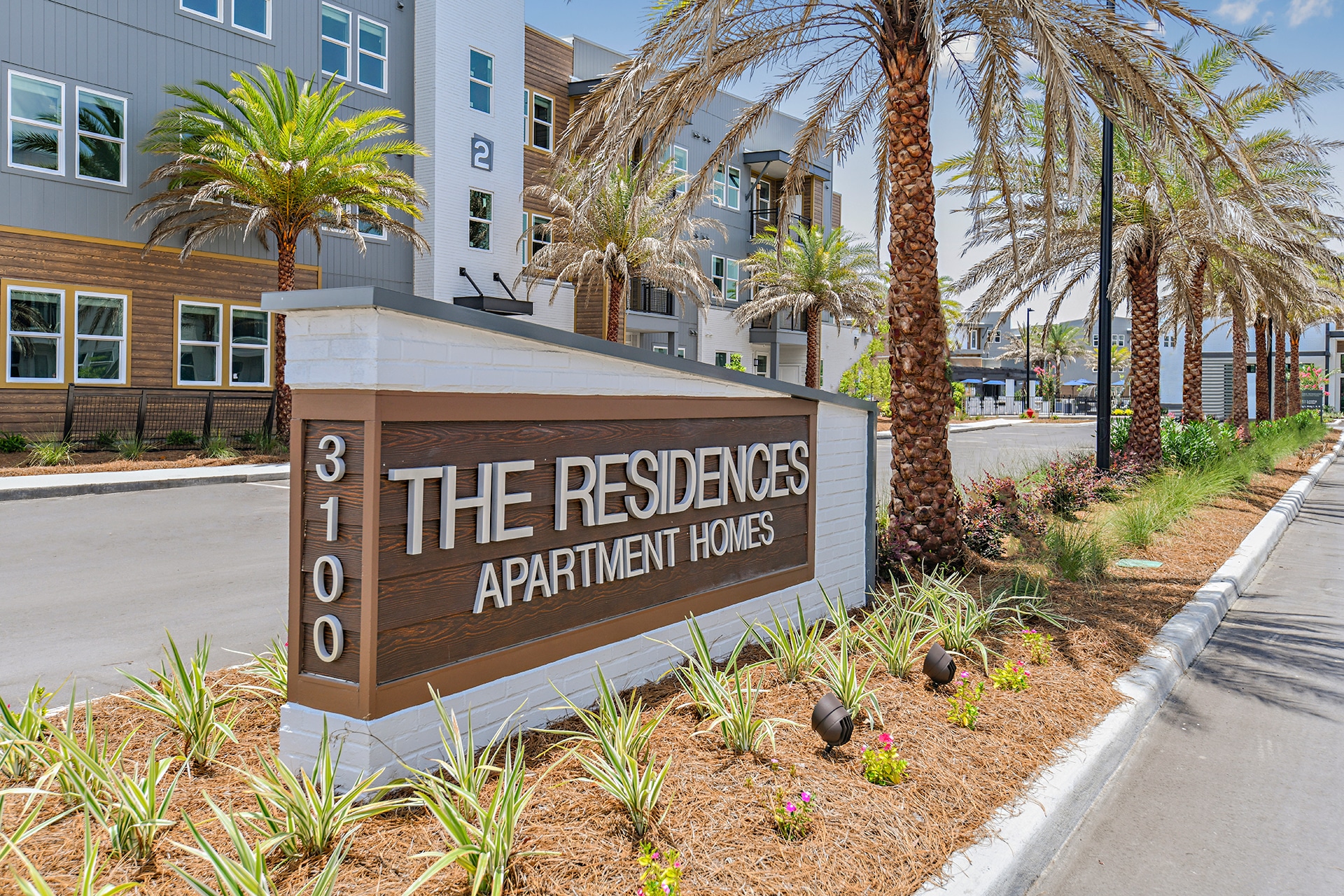 A sign that reads the residences apartment complex.