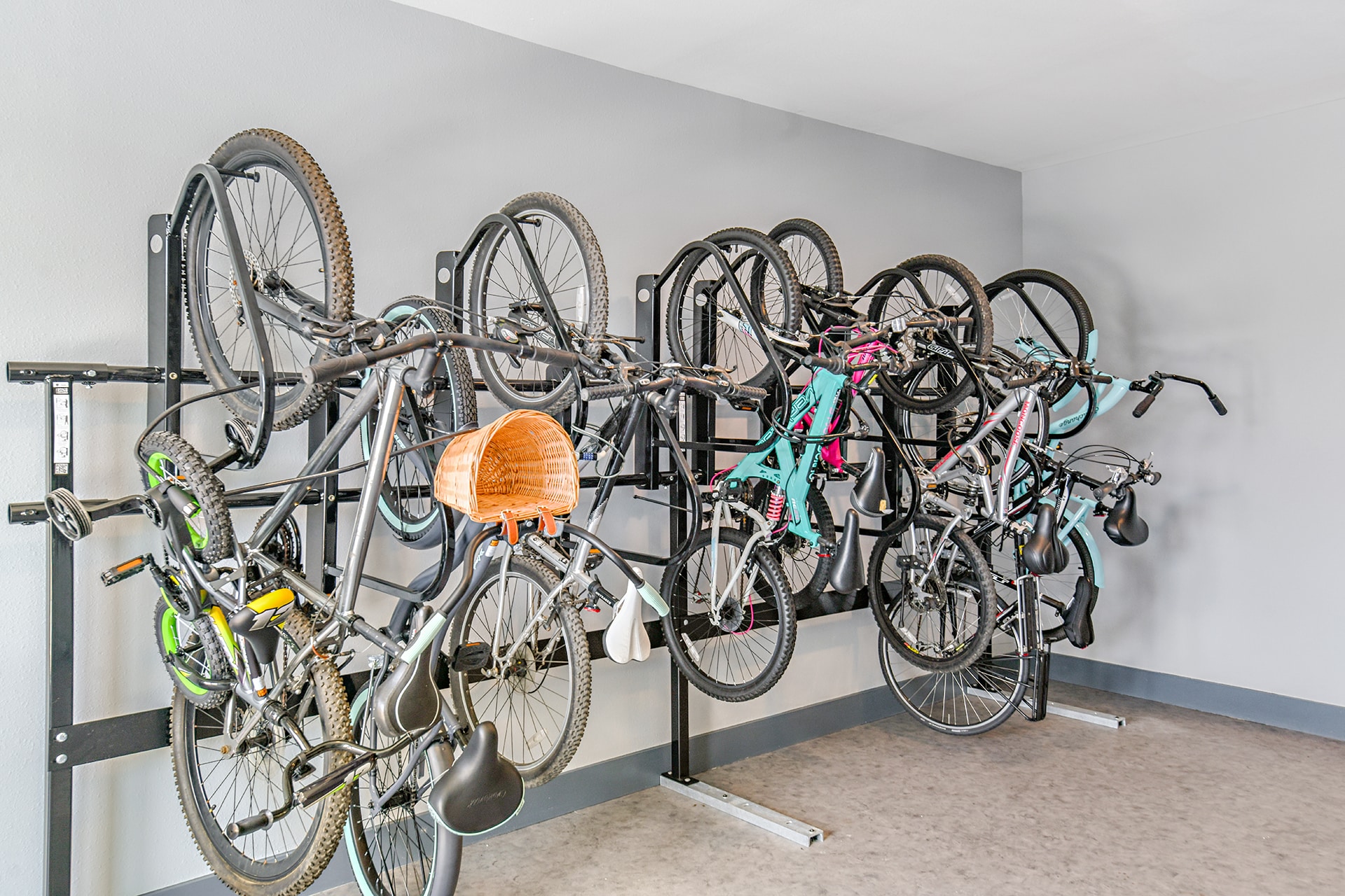 A room with several bicycles on a rack.
