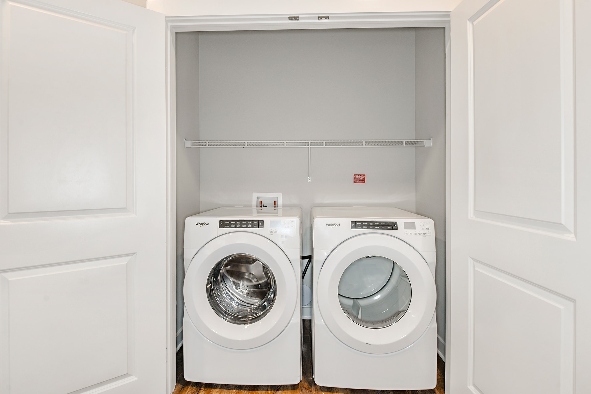 A laundry room with two washers and dryers.