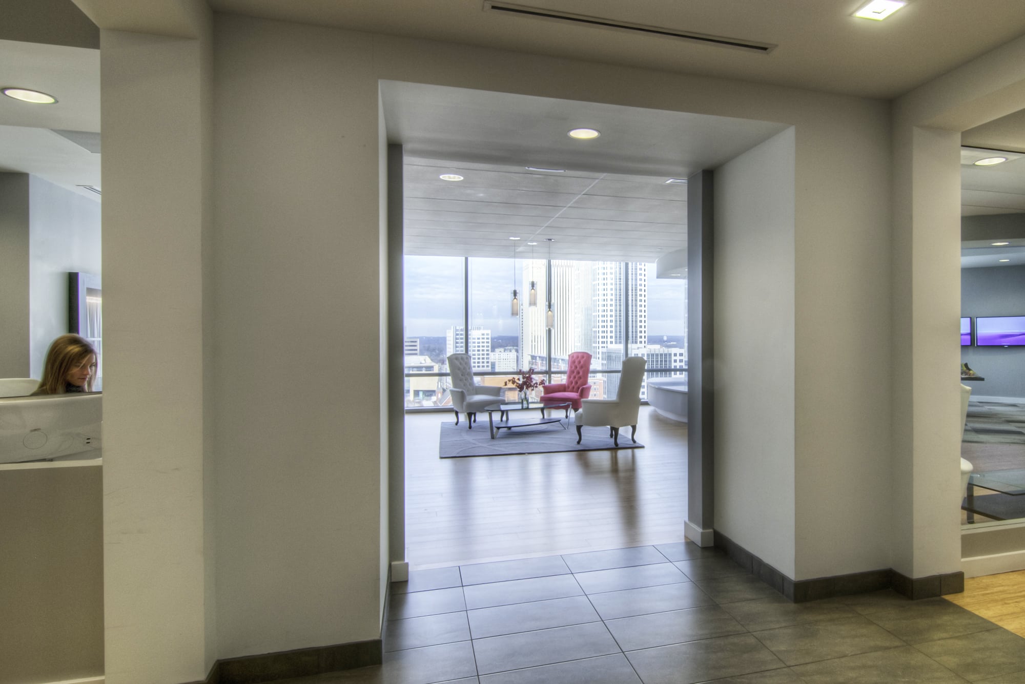 The lobby of a modern office building with a view of the city.