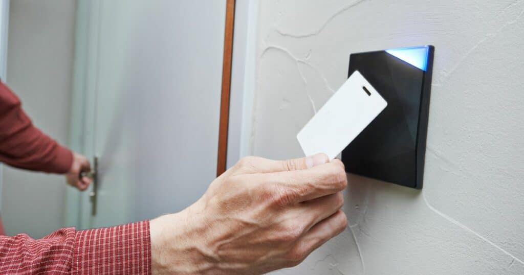 Person using a keycard to access a secure door.