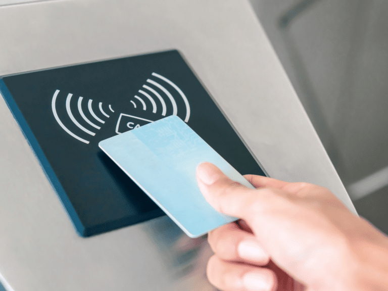 A person is using a contactless card for an electronic access low voltage system